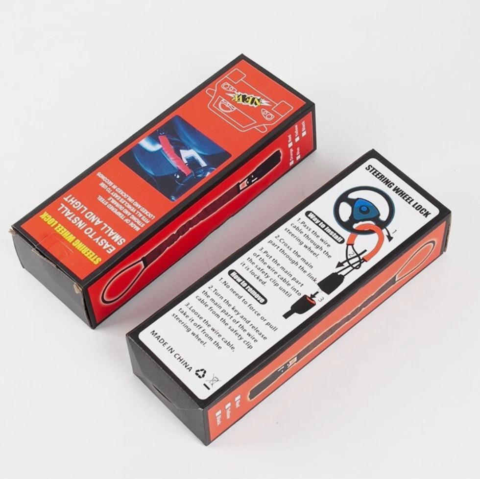 Two boxes with cabled car steering wheel lock on a white background