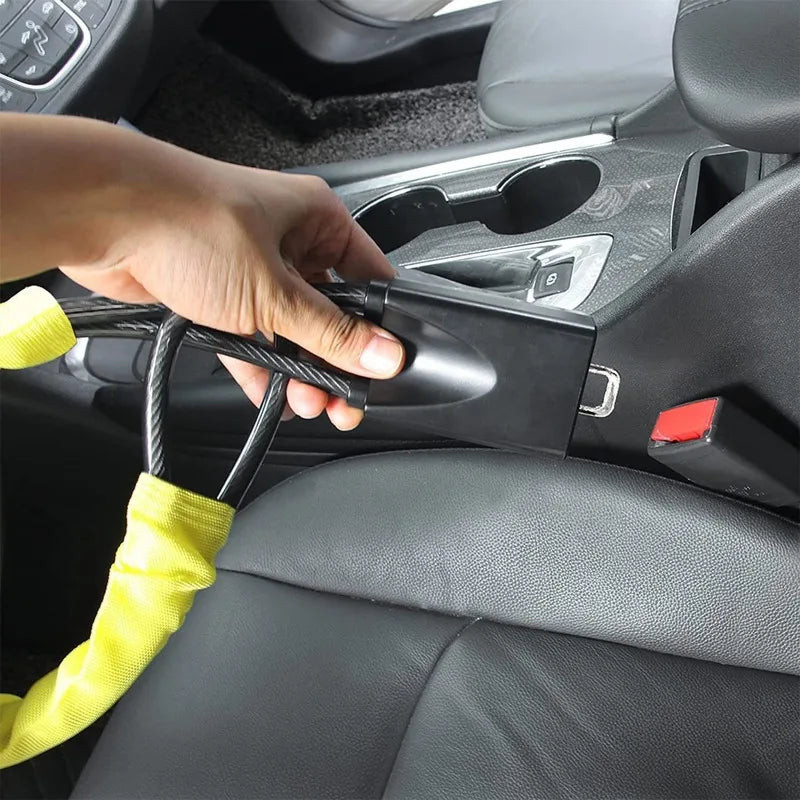 Yellow cabled car steering wheel lock being inserted to the seatbelt socket 