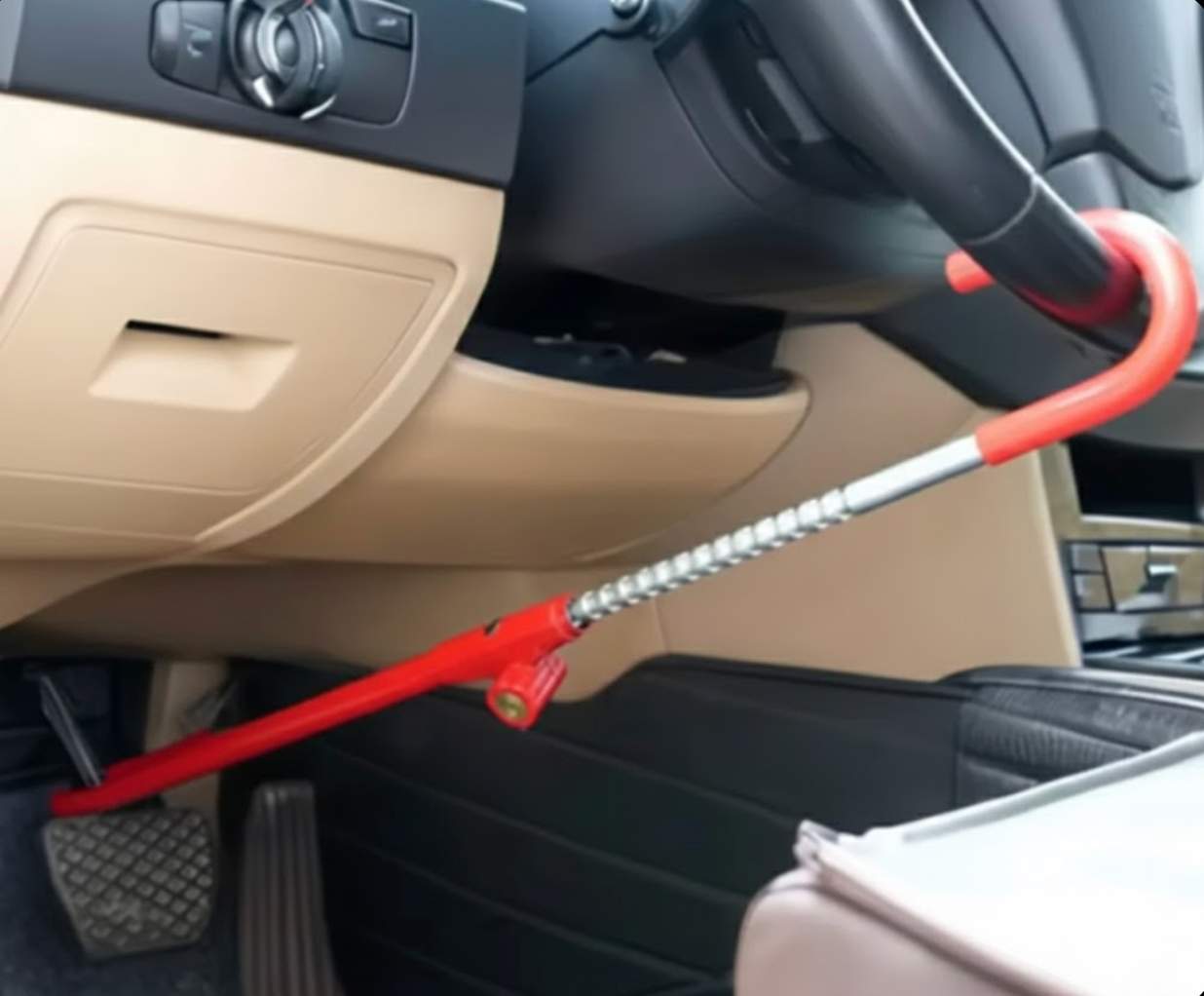 Red steering wheel to brake pedal lock installed in a car