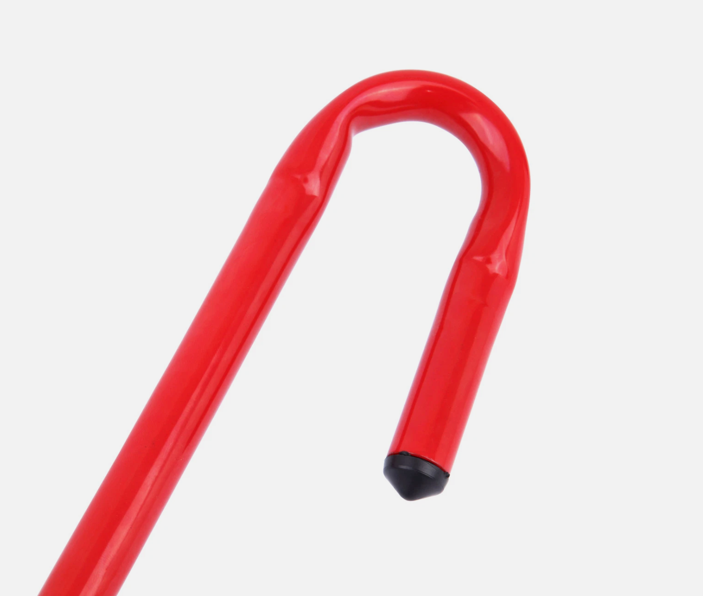 Close up of red part that fits to the brake pedal of the steering wheel to brake pedal lock on a white background