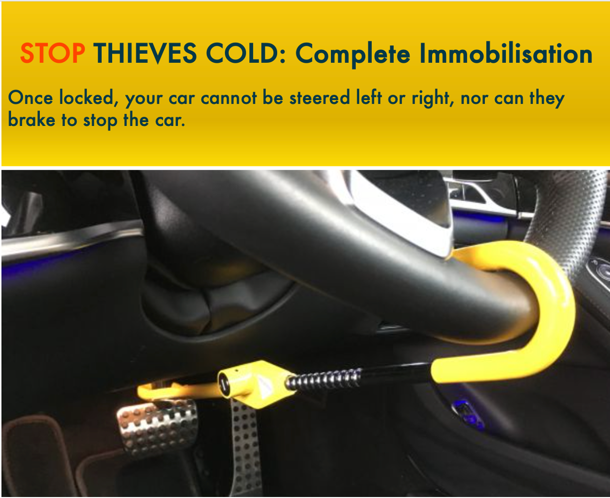 Car steering wheel lock with yellow handle and black cable, placed on a car's steering wheel.